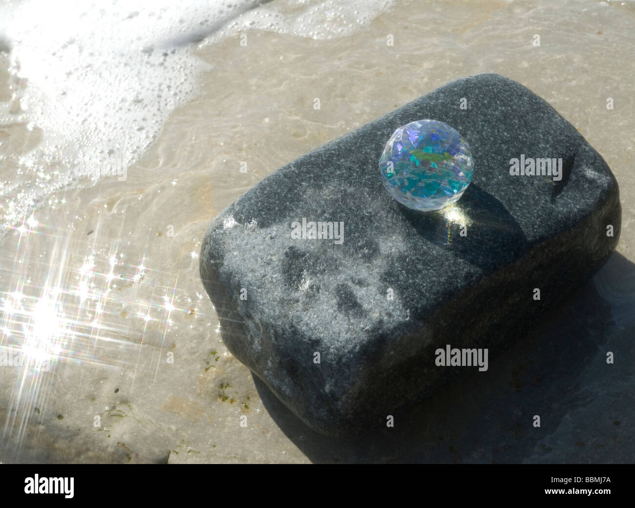 Glas Kristall auf Felsen mit Meerblick Stockfoto