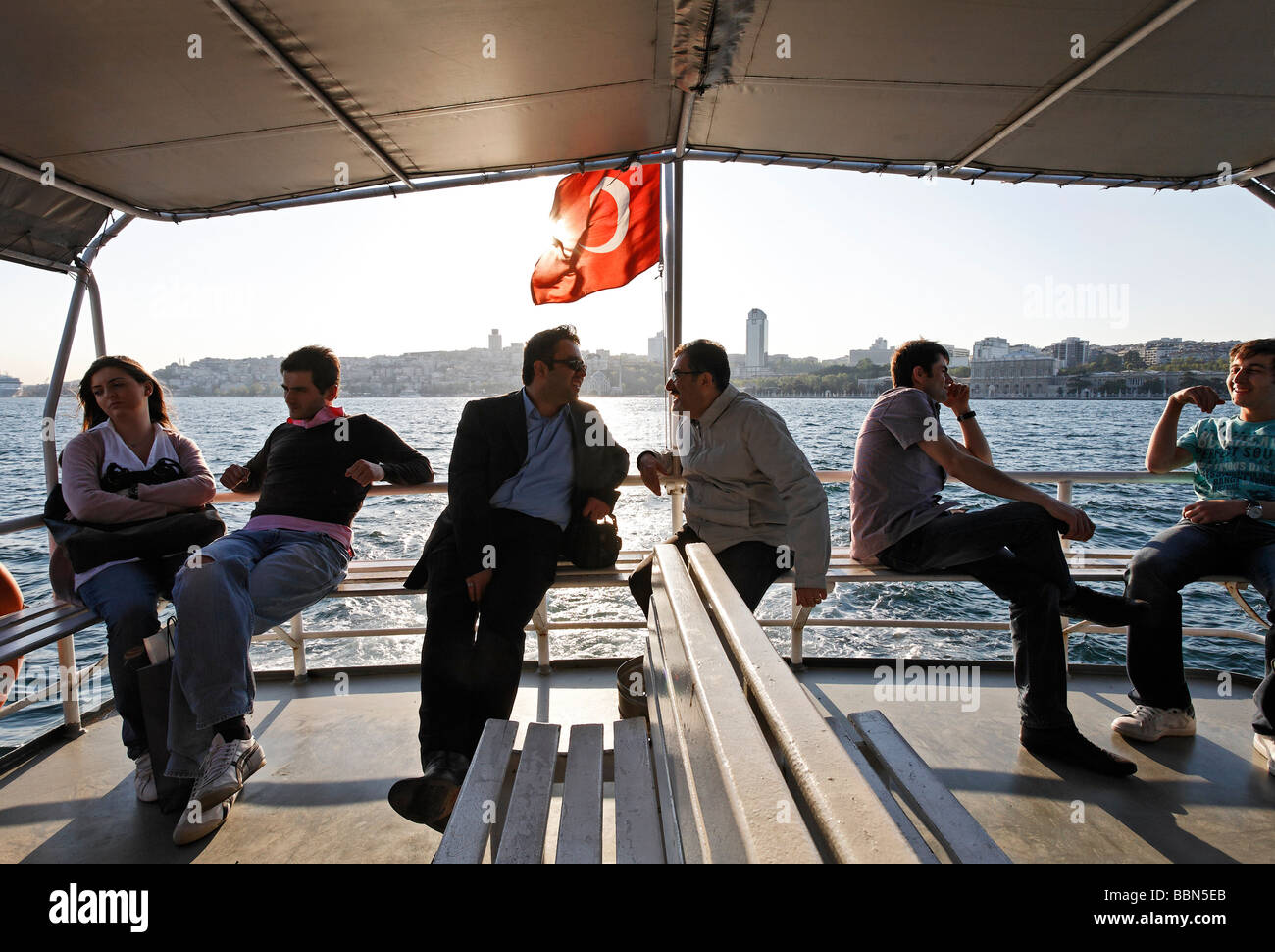 Fähre am Goldenen Horn, Passagiere sitzen auf der Terrasse unter einer Markise, Hintergrundbeleuchtung, Istanbul, Türkei Stockfoto