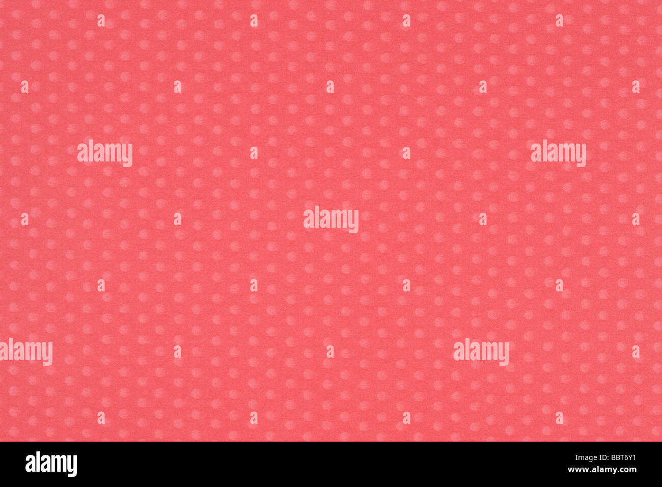 Rötlich-rosa Papier mit Polka dots Stockfoto