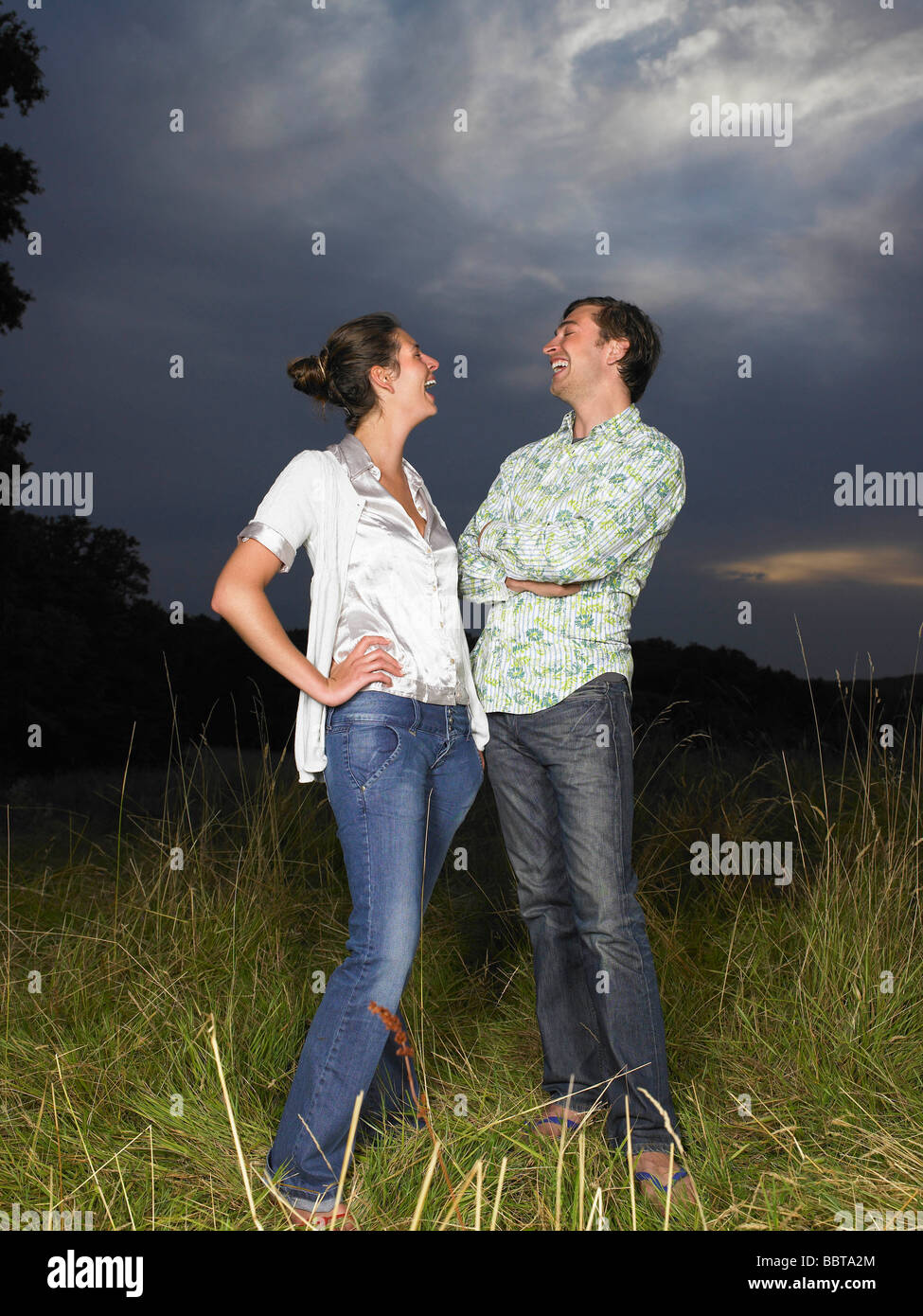 Mann und Frau in einem Feld, lachen Stockfoto