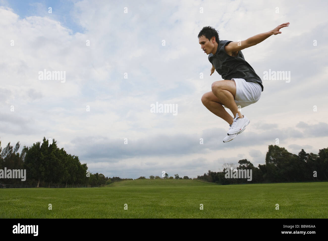 Junger Mann in die Luft springen Stockfoto