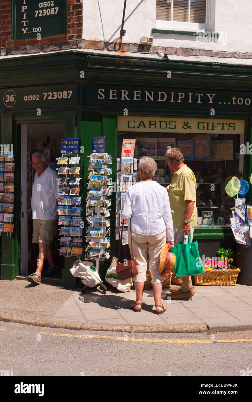 Urlauber auf der Suche um Postkarten an Karten und Geschenke Shop kaufen speichern in der Küstenstadt Southwold, Suffolk Uk Stockfoto