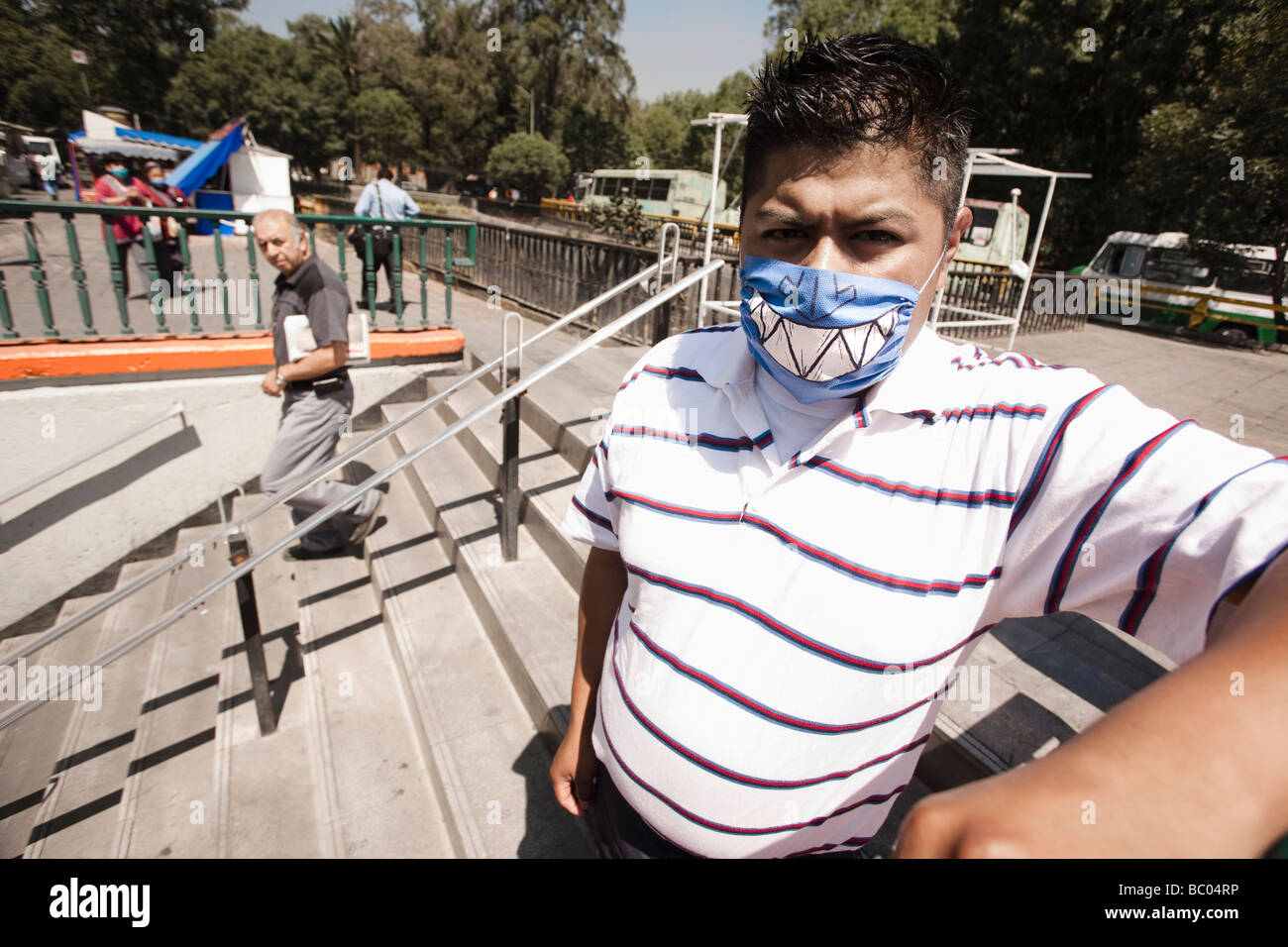 Ein Mann mit einer bemalten Maske steht am u-Bahn Ausgang während der Schweinegrippe-Epidemie in Mexiko-Stadt, DF, Mexiko. Stockfoto