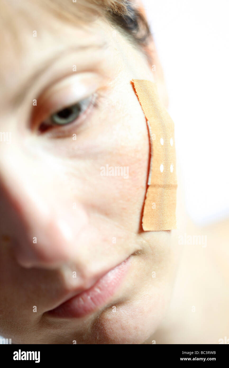 Frau hat ein Pflaster im Gesicht Stockfotografie - Alamy
