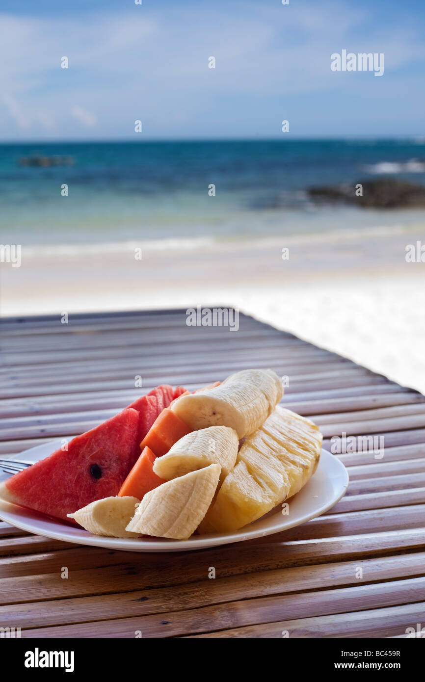 Obstsalat auf einem Holztisch blaues Meer im Hintergrund selektiven Fokus Stockfoto