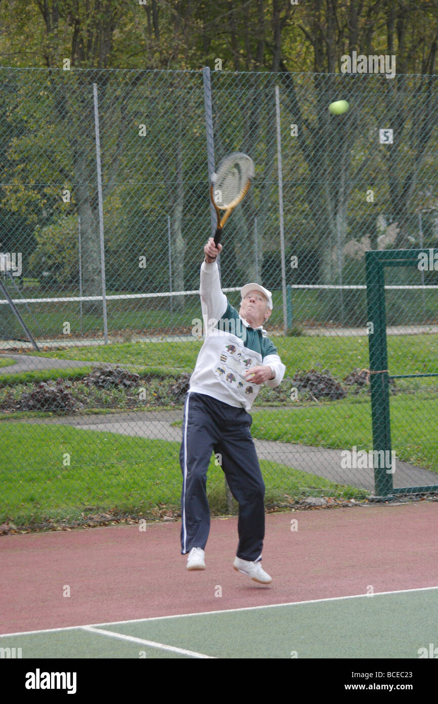 Über 80 erfahrene Tennisspieler noch genießen, Tennis spielen, zu einem guten Standard. Stockfoto