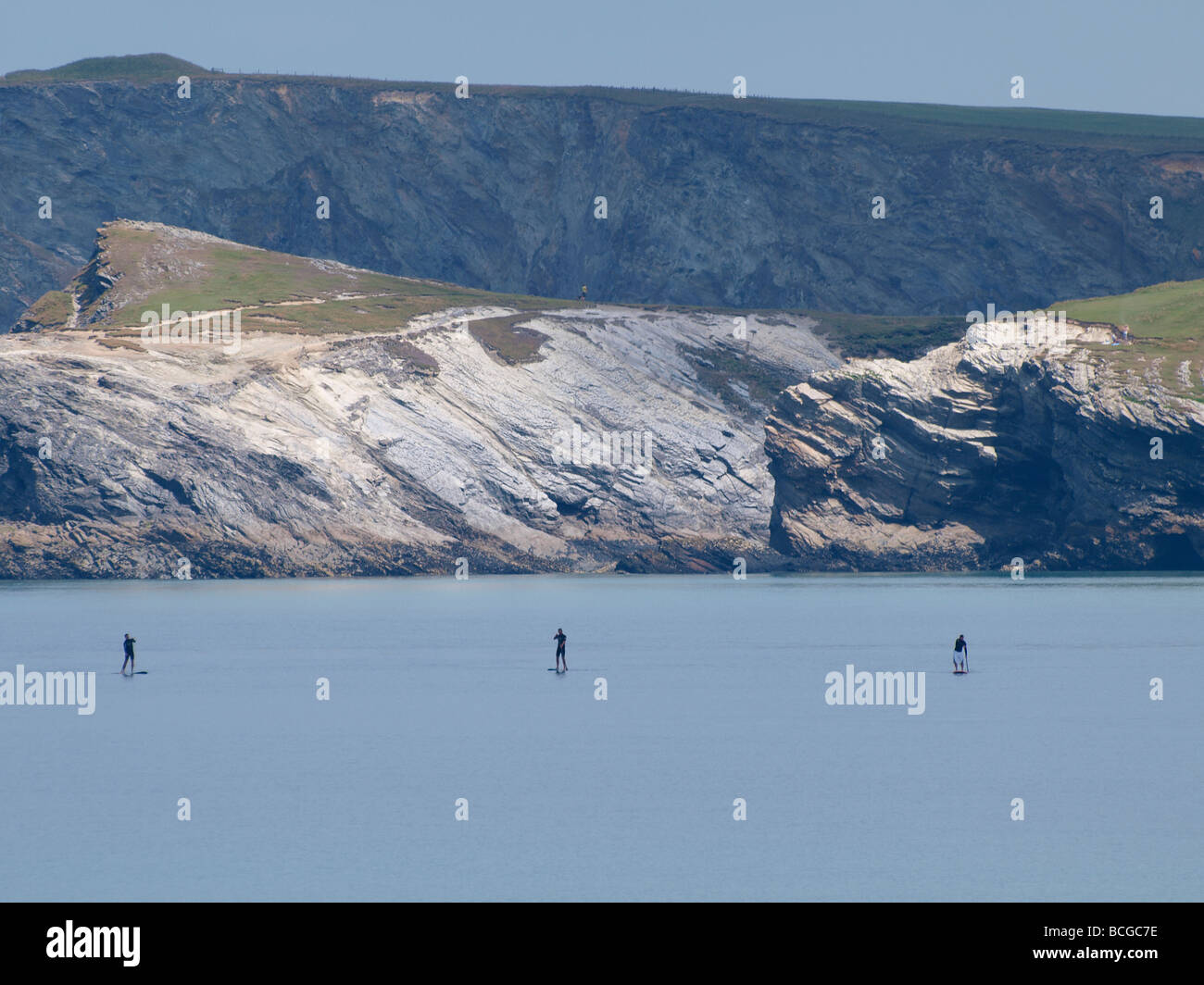 Drei Menschen auf Stand up Paddeln Boards überquert die Bucht bei Newquay Stockfoto