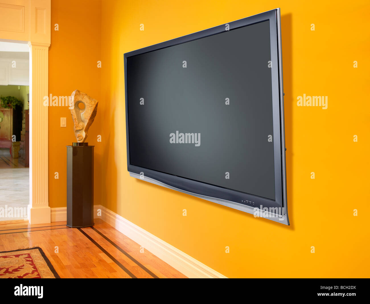 Plasma TV Fernseher gelbe Wand horizontal Stockfoto