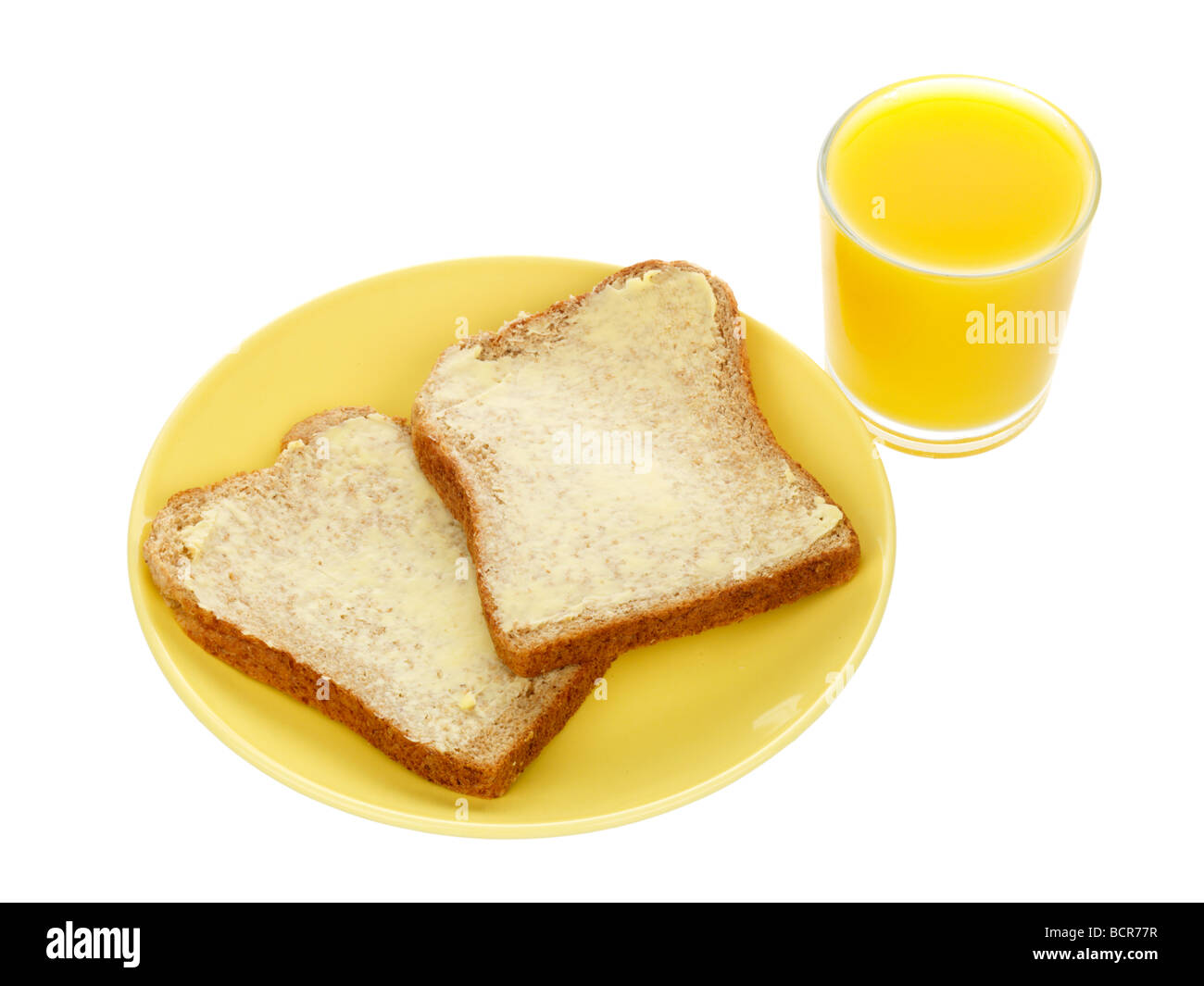 Schwarzbrot mit Butter und Orangensaft Stockfoto