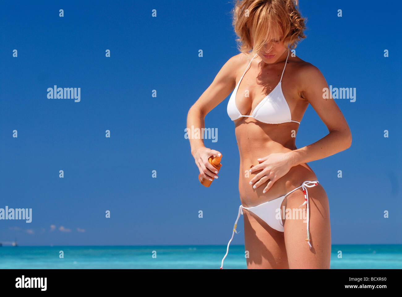 Frau am Strand, Sonnenschutz Stockfoto