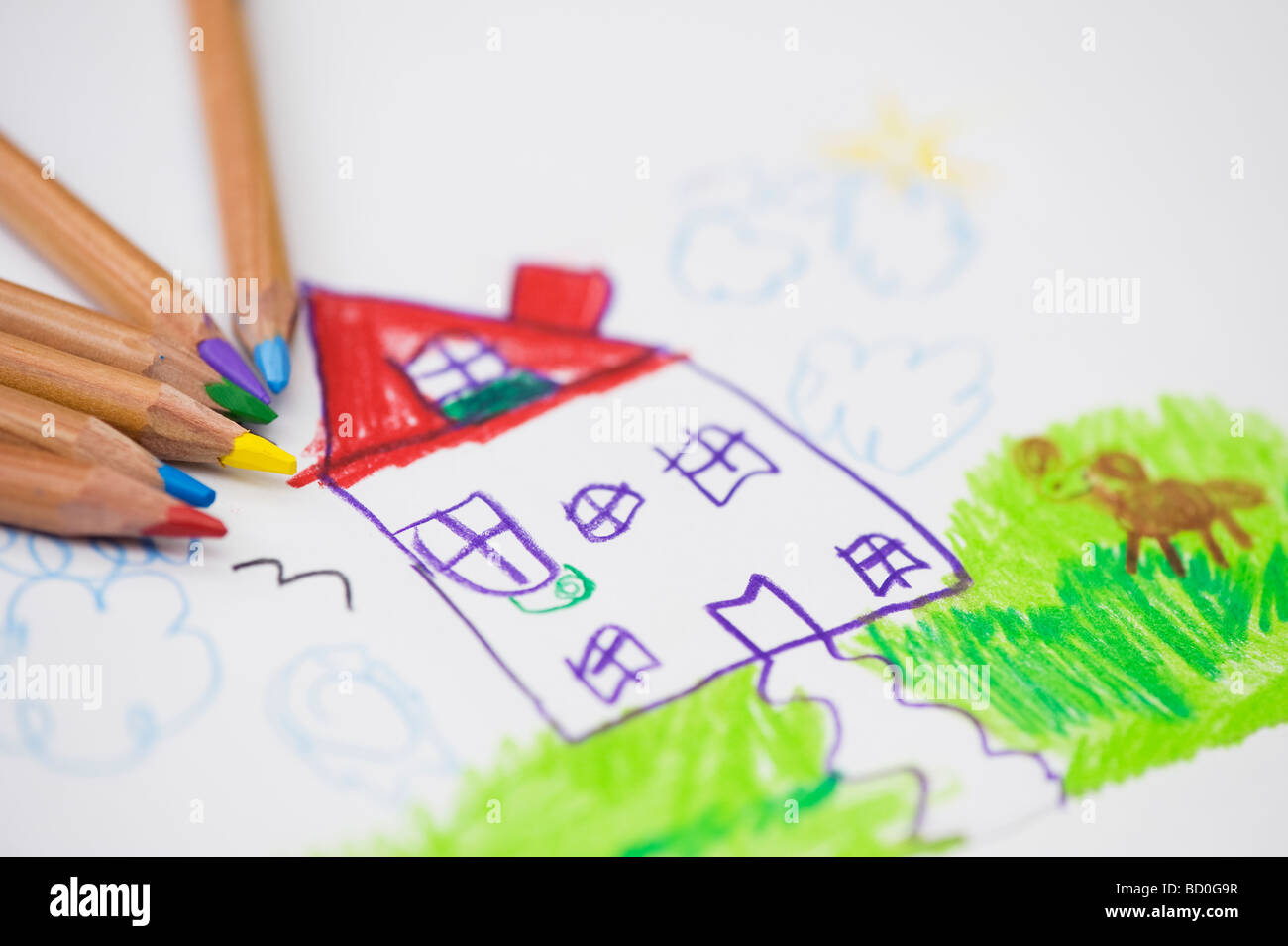 Kind ist von einem Haus und Hund mit Farbstiften zeichnen Stockfoto