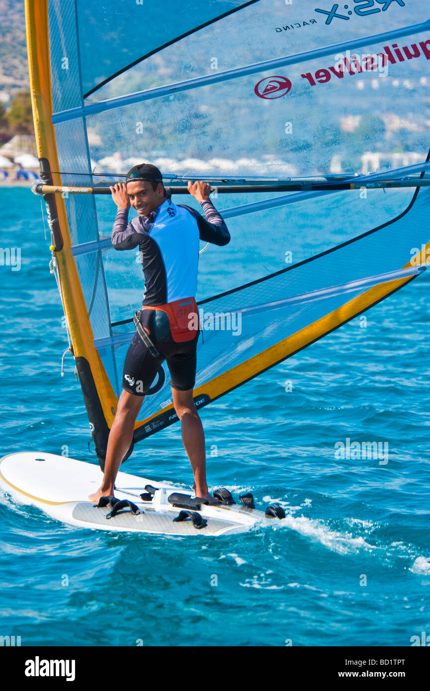 Junge, die lächelnd auf einem Surfbrett Stockfoto