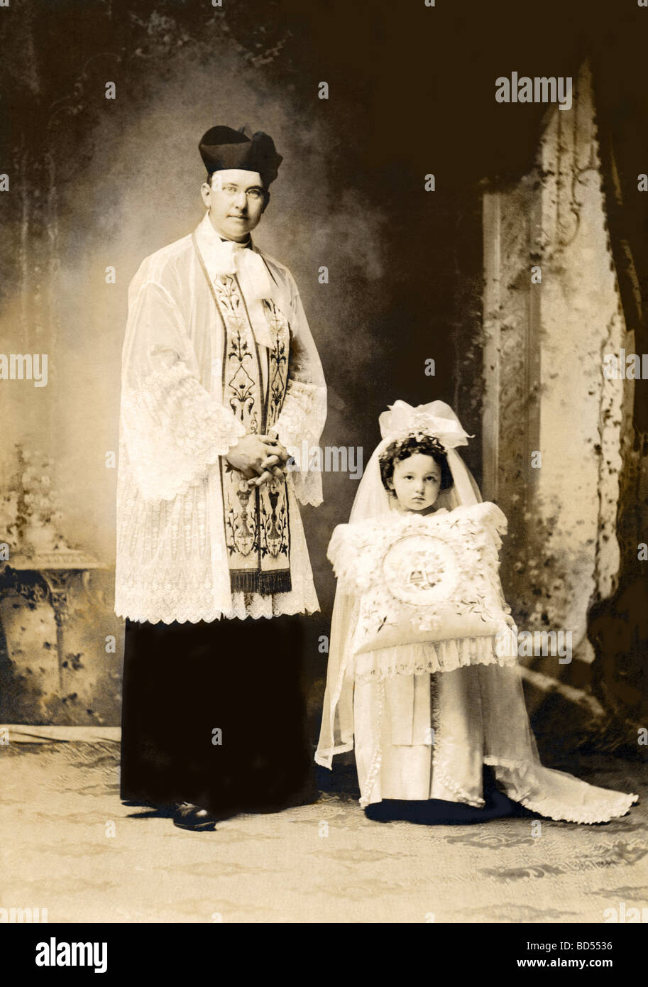 Priester mit kleinen Mädchen Ringträger mit Kissen Stockfoto