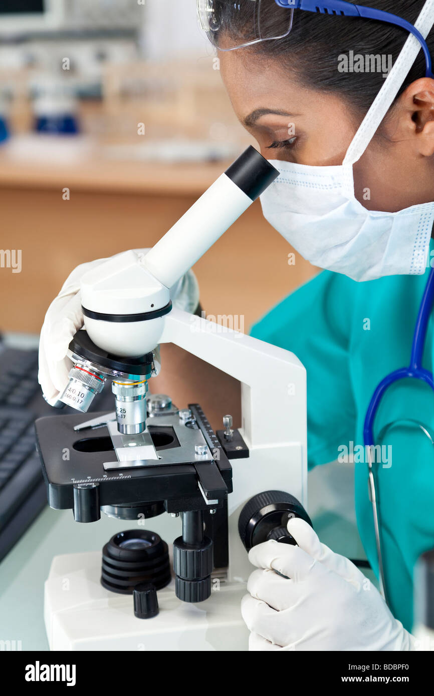 Eine asiatische Frauen Arzt oder wissenschaftlicher Mitarbeiter mit ihrem Mikroskop im Labor Stockfoto