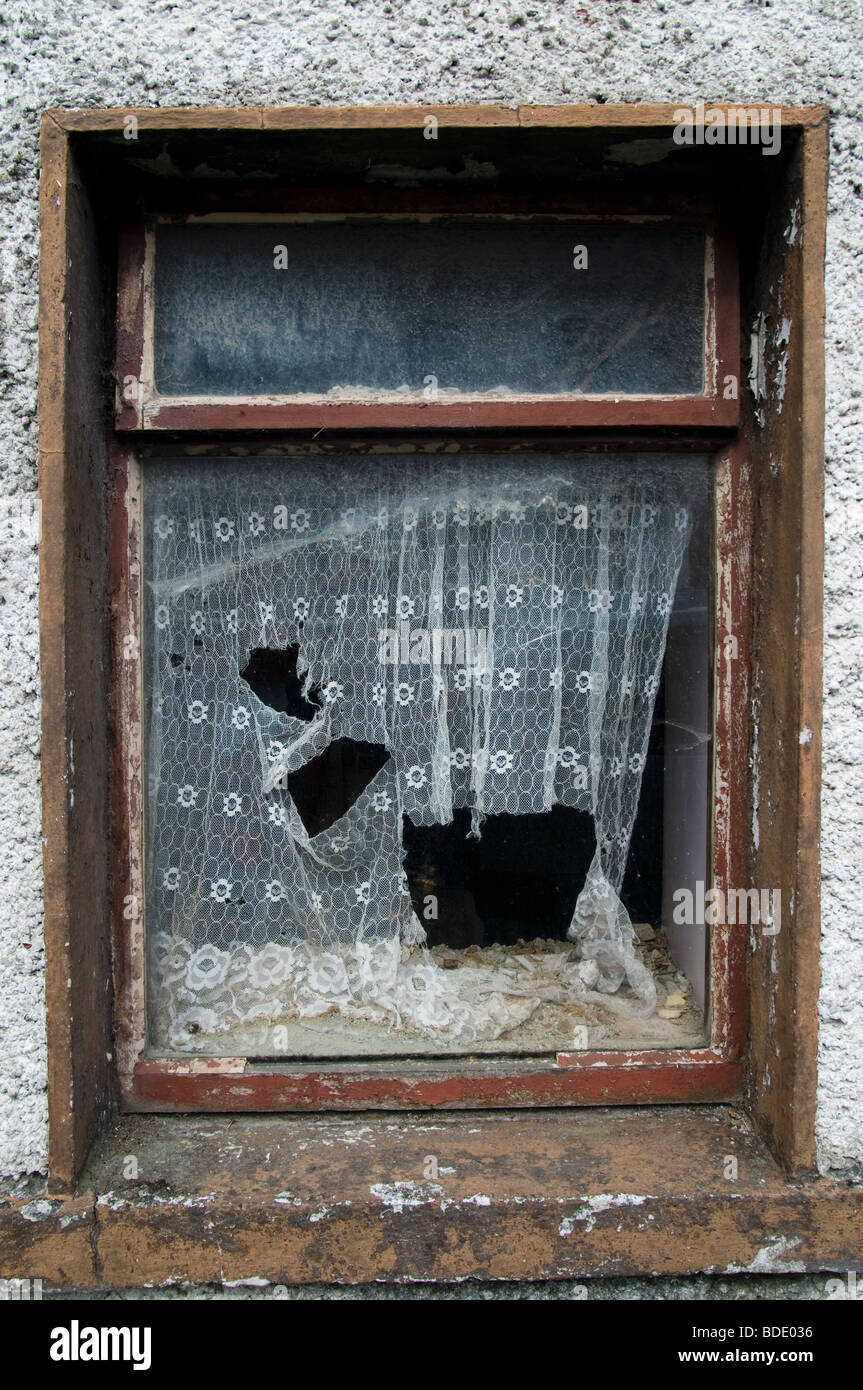 Ein Fenster eines alten vernachlässigten Hauses in einem irischen Dorf - Louisburgh, County Mayo, Irland Stockfoto