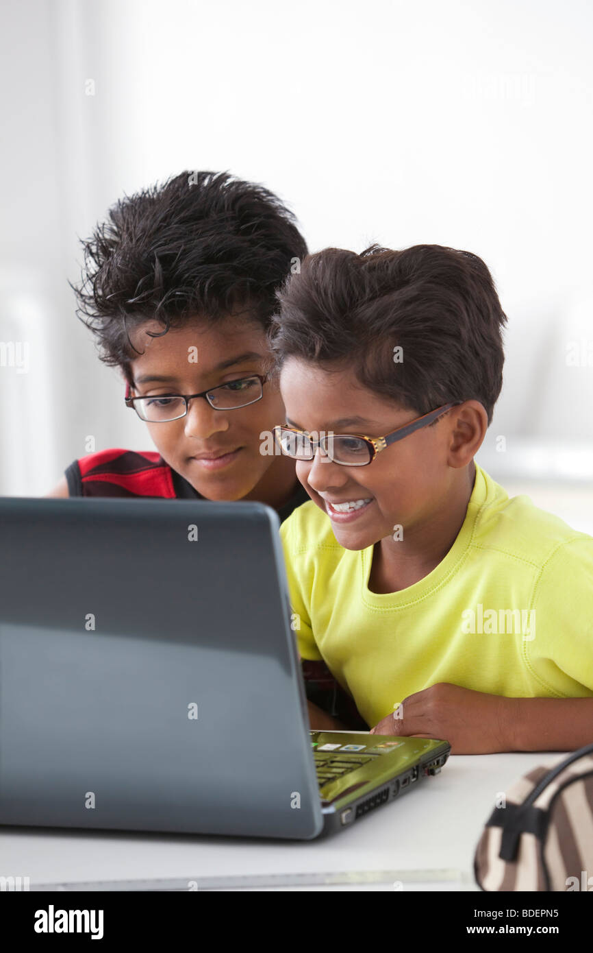 Zwei Brüder hinter einem laptop Stockfoto