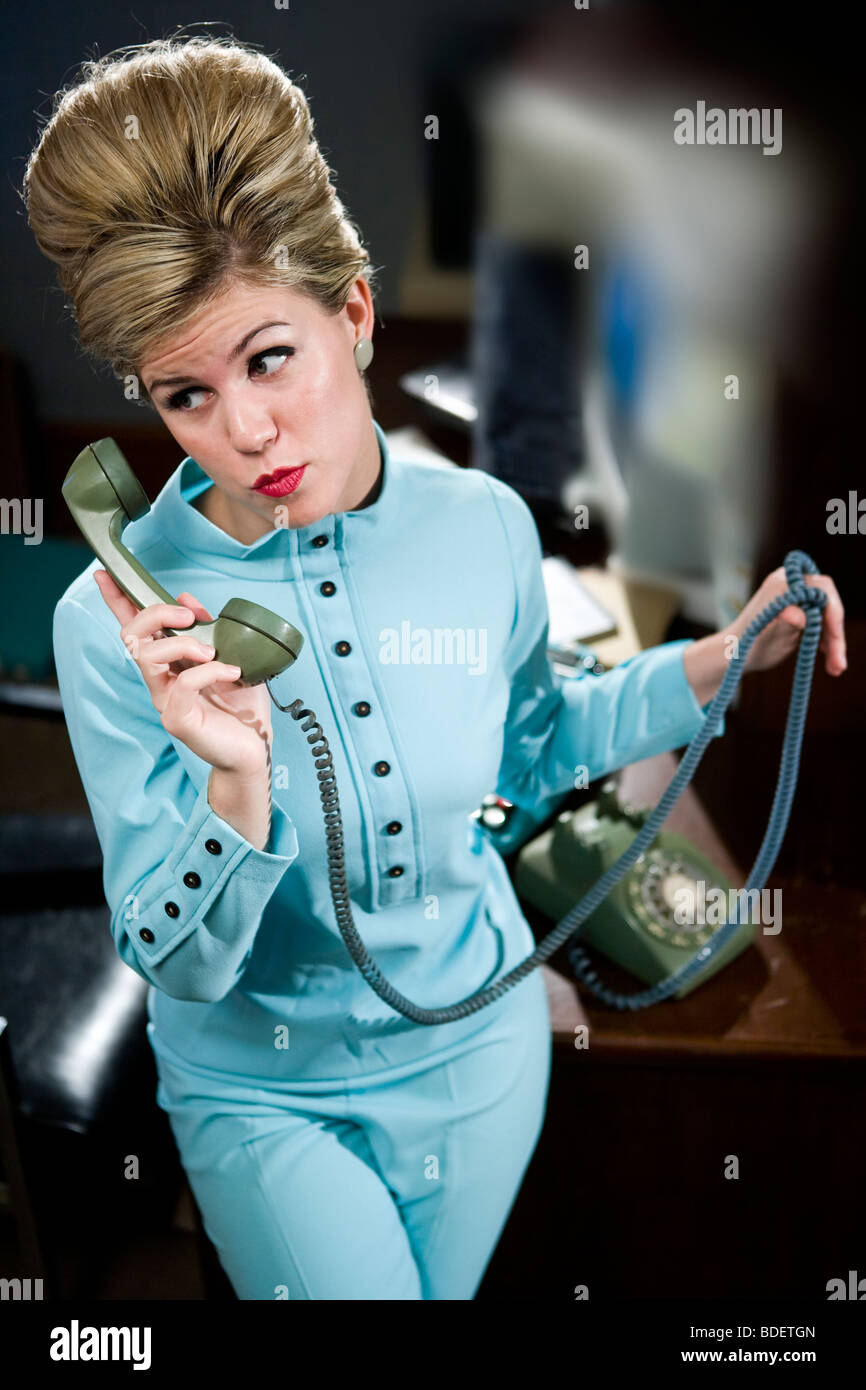 Vintage Porträt der jungen Sekretärin mit Bienenstock ans Telefon Stockfoto