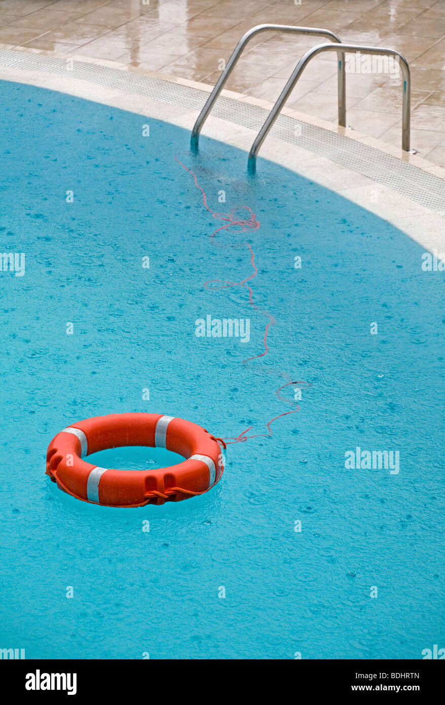 Schwimmbad mit Lebensretter im Regen Stockfoto