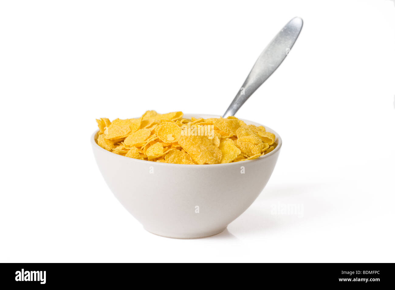 Cornflakes Müsli in eine weiße Schale mit Löffel Stockfotografie
