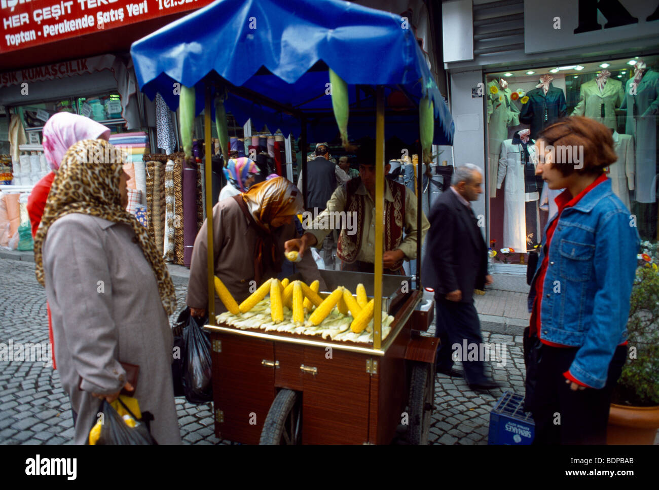 Istanbul Türkei Frauen Corn On The Cob von Straßenhändler kaufen Stockfoto