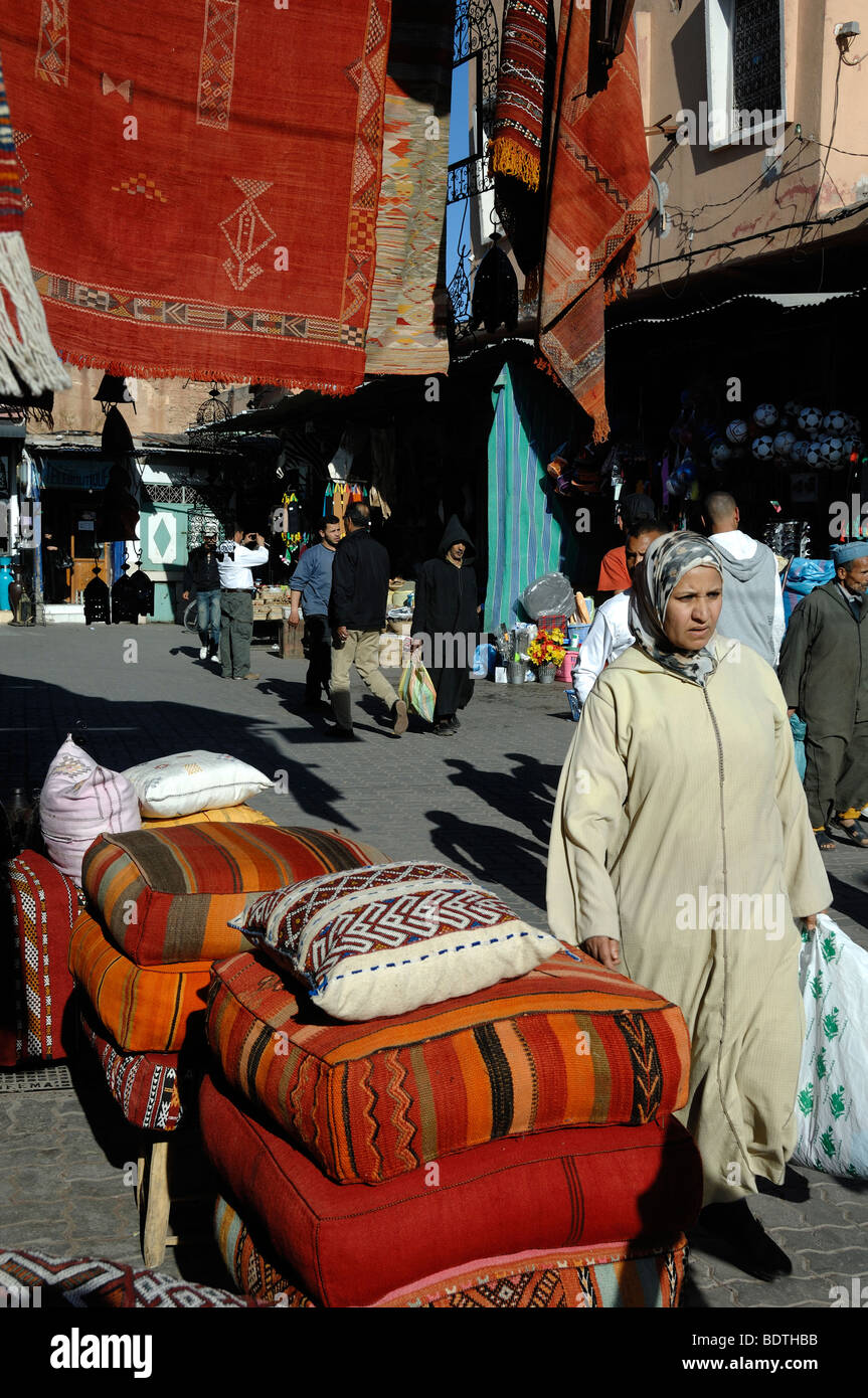 Eine marokkanische Frau geht durch die Teppich Basar, Markt oder Souk, Place Aux Epices, Marrakesch, Marokko Stockfoto