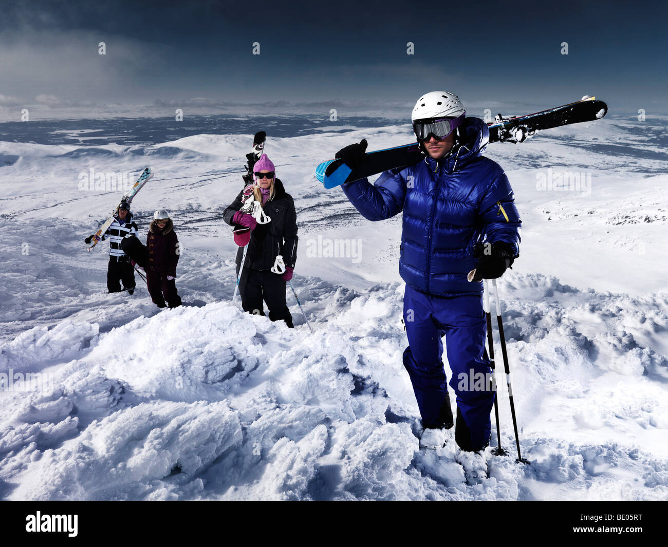 4 Personen an der Spitze des Berges posiert. Stockfoto