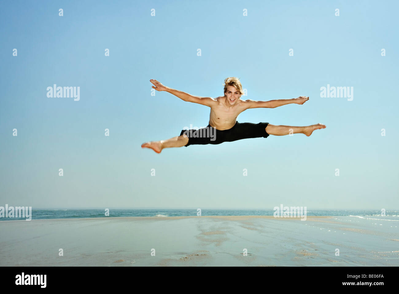 Junger Mann tun teilt sich in die Luft Stockfoto