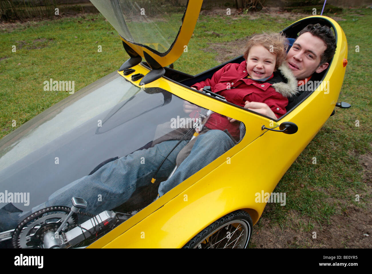 Porträt eines Vaters und seines kleinen Sohnes zusammen in einem selbstgebauten Elektromobil Stockfoto