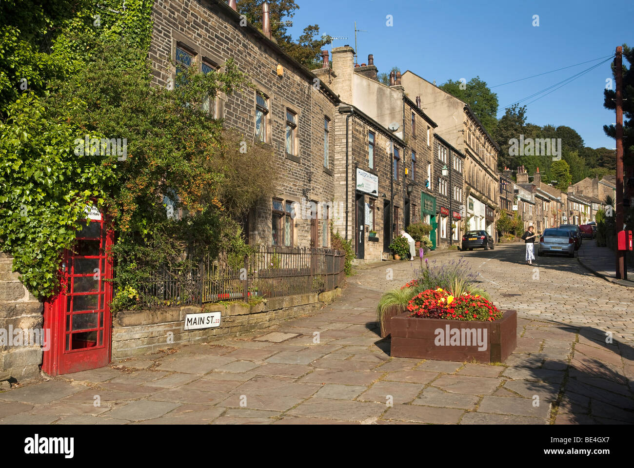 Großbritannien, England, Yorkshire, Haworth, Main Street, überwucherten K6 Telefon Box in Wand eingebaut Stockfoto