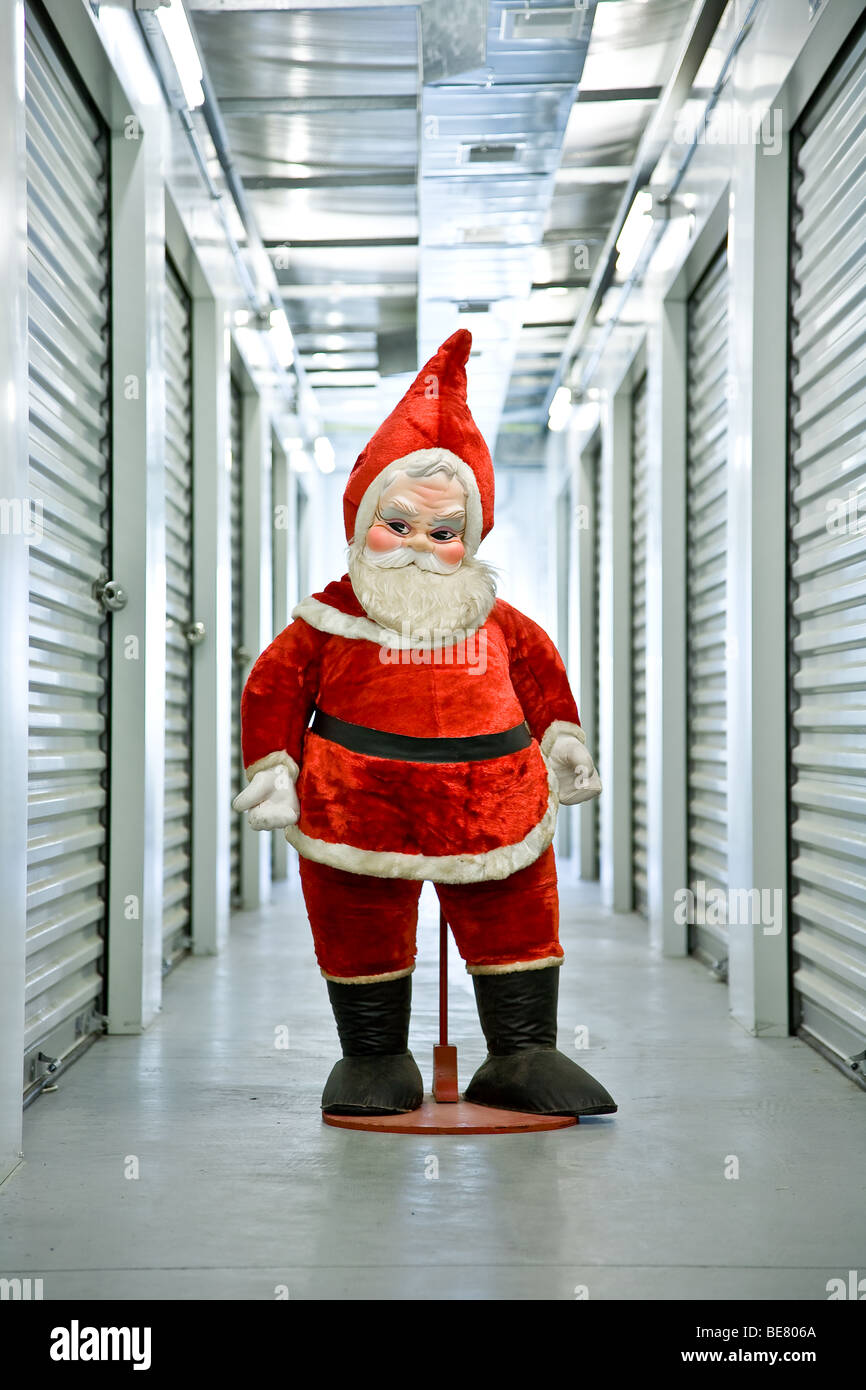 Eine 60er-Ära gefüllt Santa Claus steht in einem industriellen Flur innerhalb seiner Self-Storage-Einheit Stockfoto