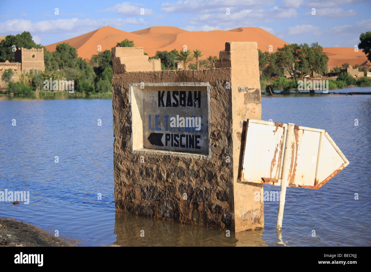 Überschwemmungen nach Regen eine Kasbah-Siedlung unter den Erg Chebbi Sanddünen in der Sahara-Wüste in der Nähe von Merzouga, Marokko umgibt Stockfoto