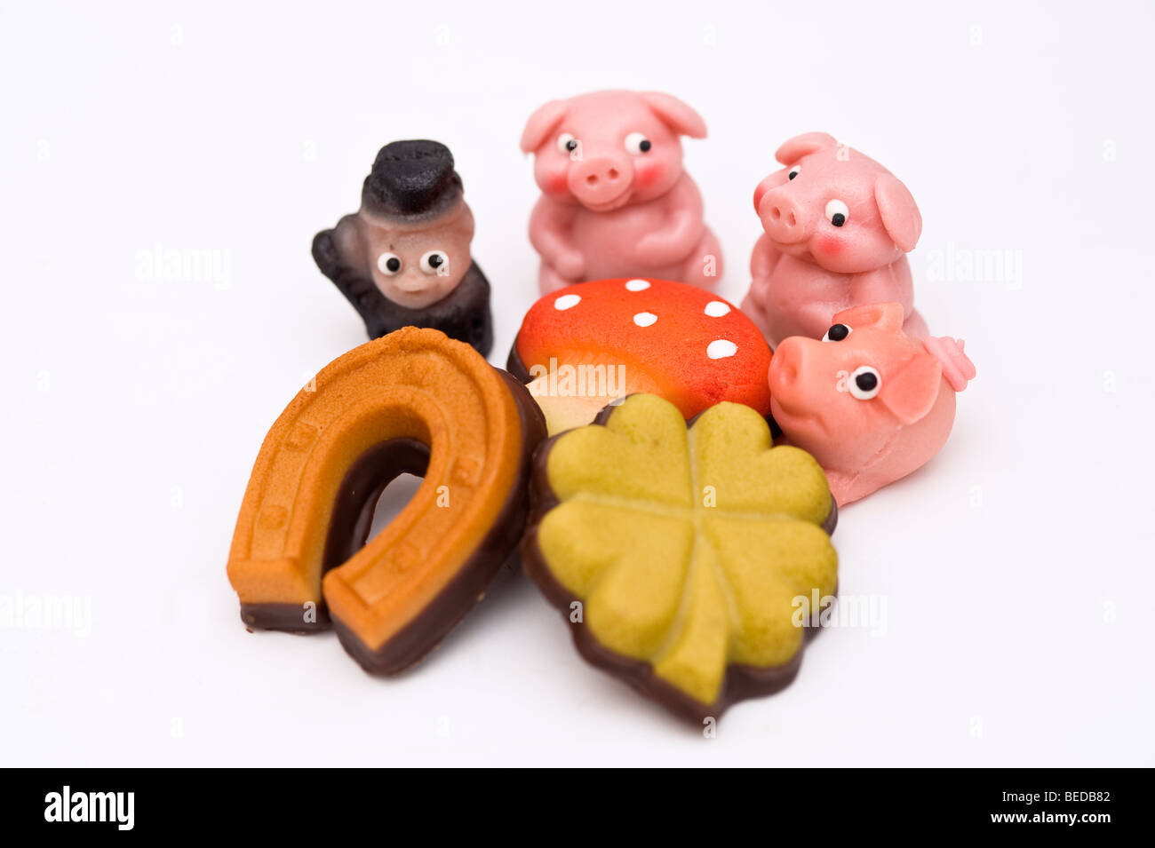 Glücksbringer aus Marzipan gemacht: Schweine, Schornsteinfeger, Kleeblatt, Pilz und ein Hufeisen Stockfoto