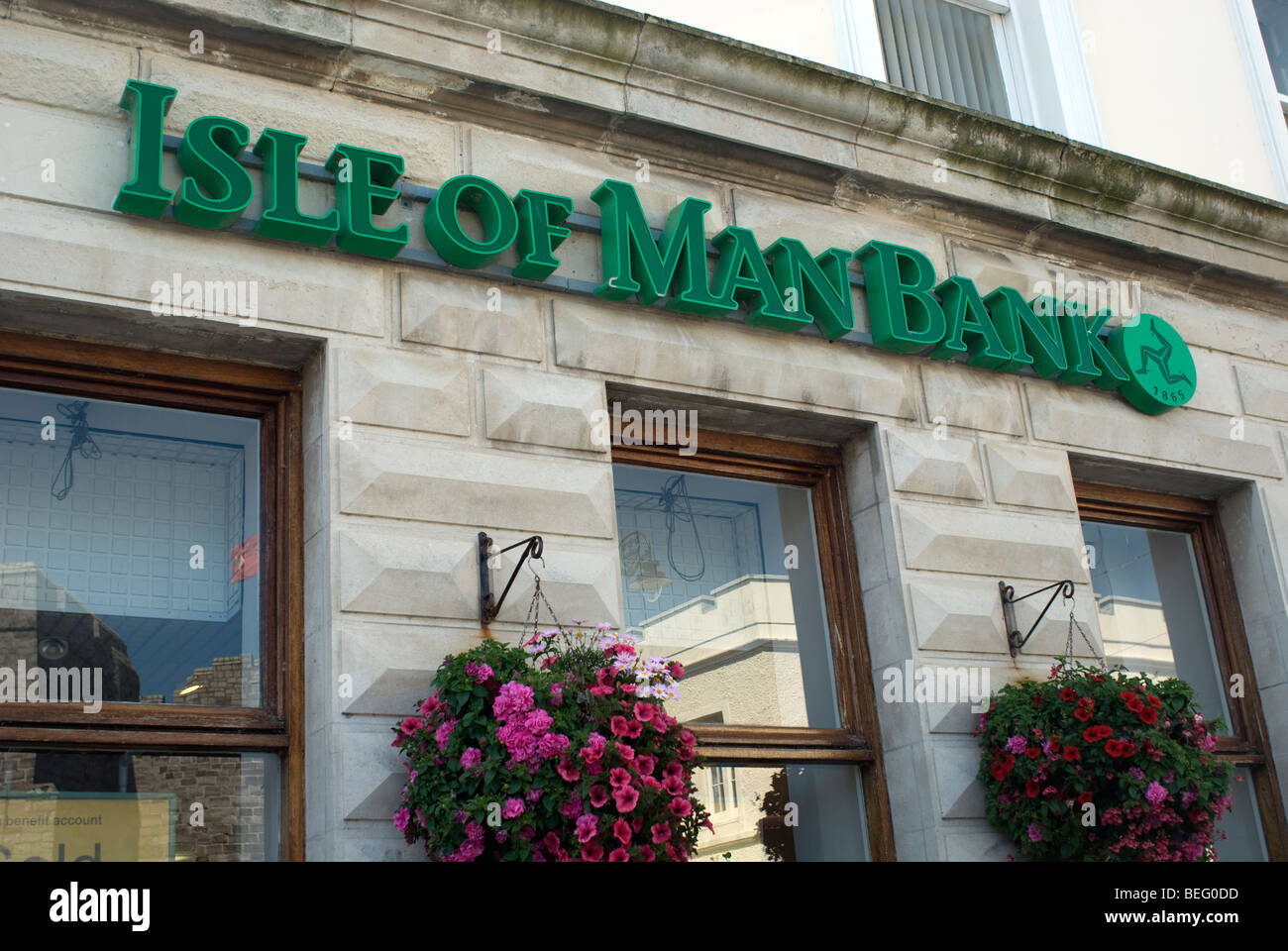 Detail der Fassade der Isle Of Man Bank in Castletown, Isle Of man. Die wichtigsten Zeichen, Logo und eine Blütenpracht sind sichtbar. Stockfoto