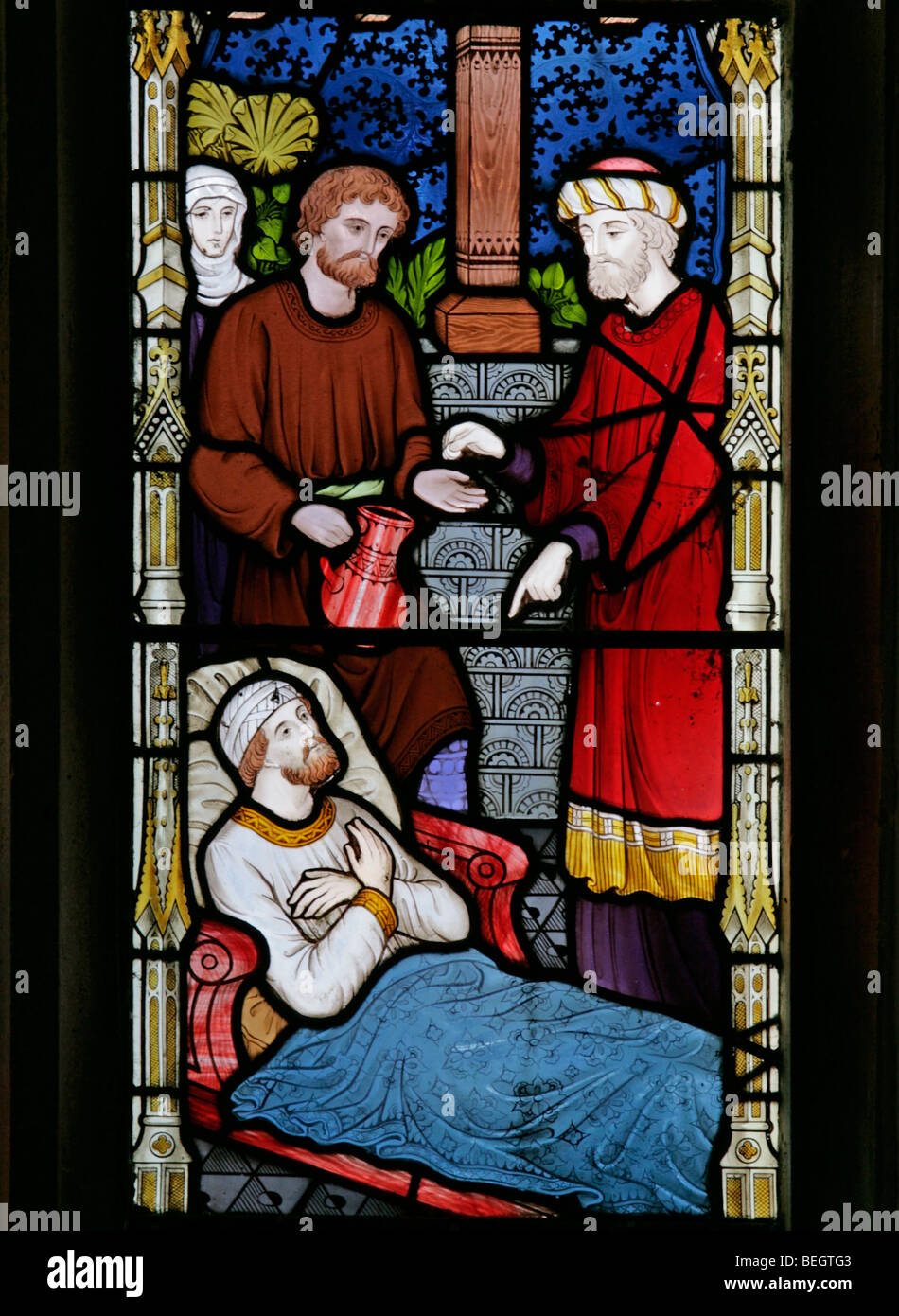 Ein Glasfenster von Frederick Preedy, das Sechs Taten von Corporate Mercy darstellt - Visti the Sick, St Mary the Virgin, Gunthorpe, Norfolk Stockfoto