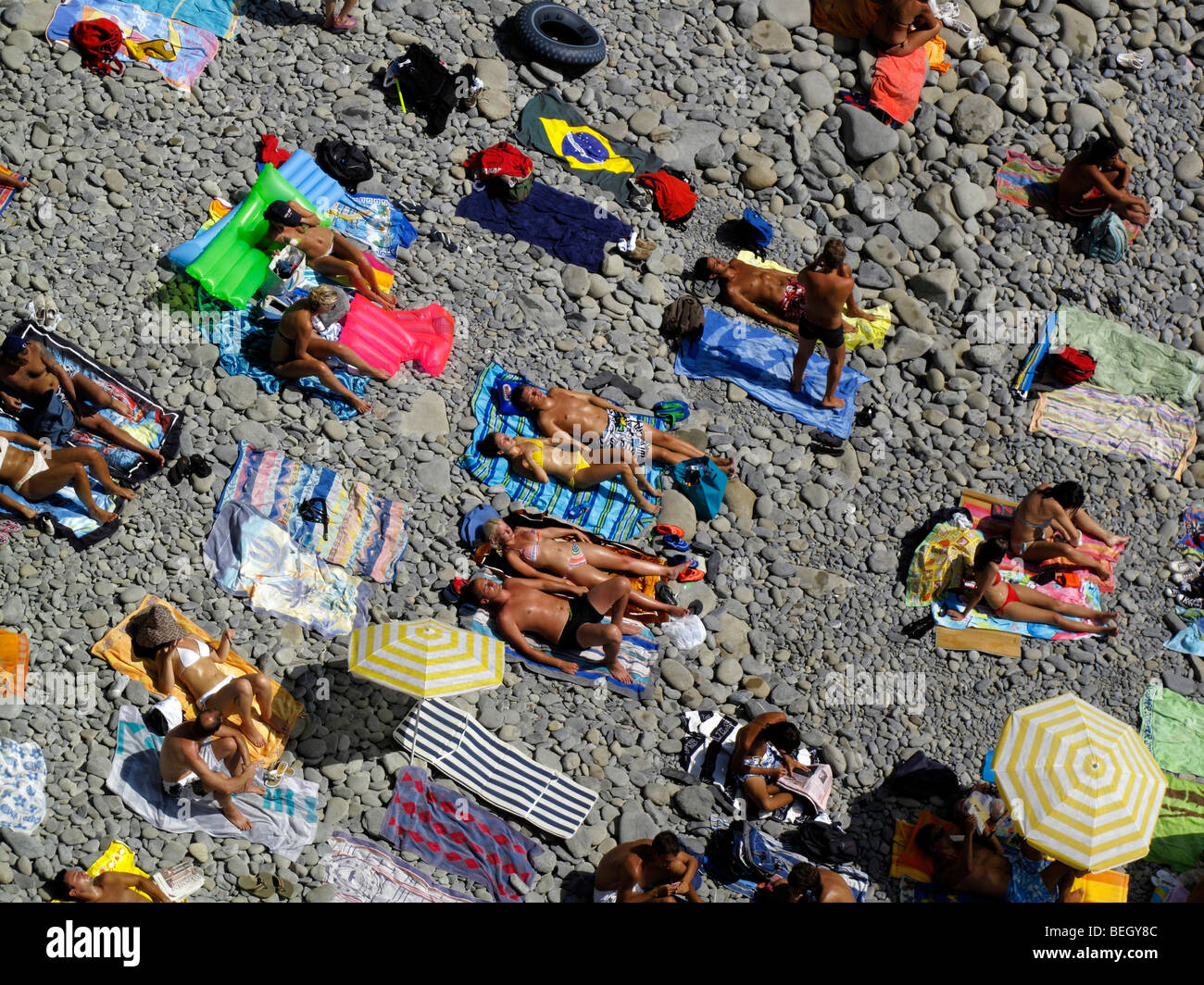 Sonnenanbeter am Strand von Riomaggiore in der Region Cinque Terre an der italienischen Riviera oder Riviera di Levanto Stockfoto