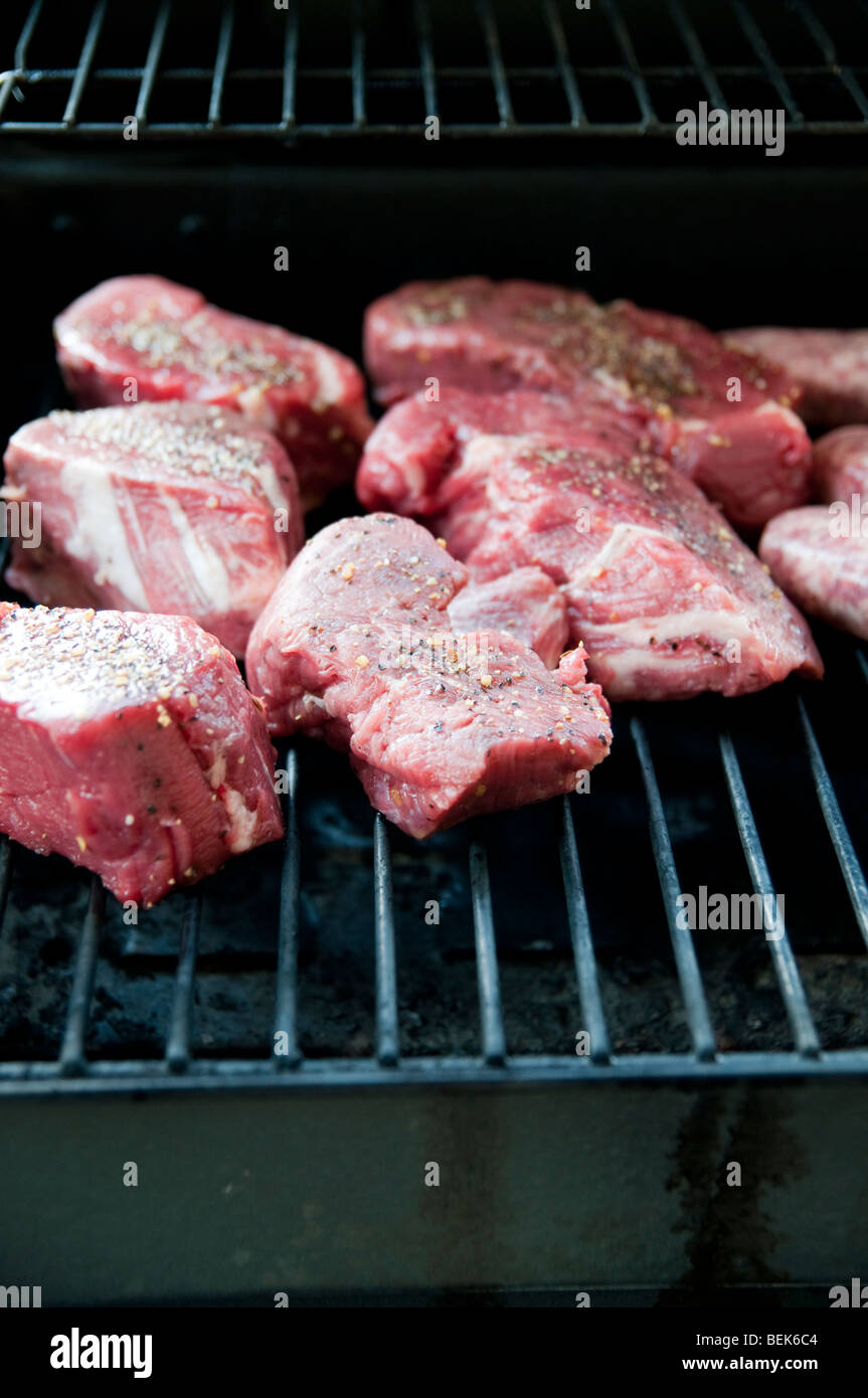 Erfahrene rohes Steak Koteletts auf einem BBQ-Grill Stockfoto