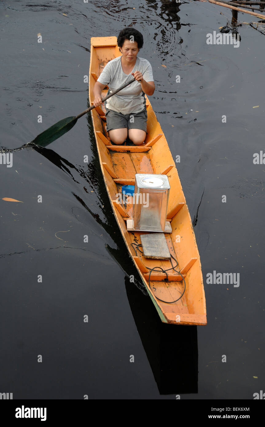Melanau Frau paddeln in hölzernen Kanu Tellian Kampung Mukah Sarawak Malaysia Borneo Stockfoto