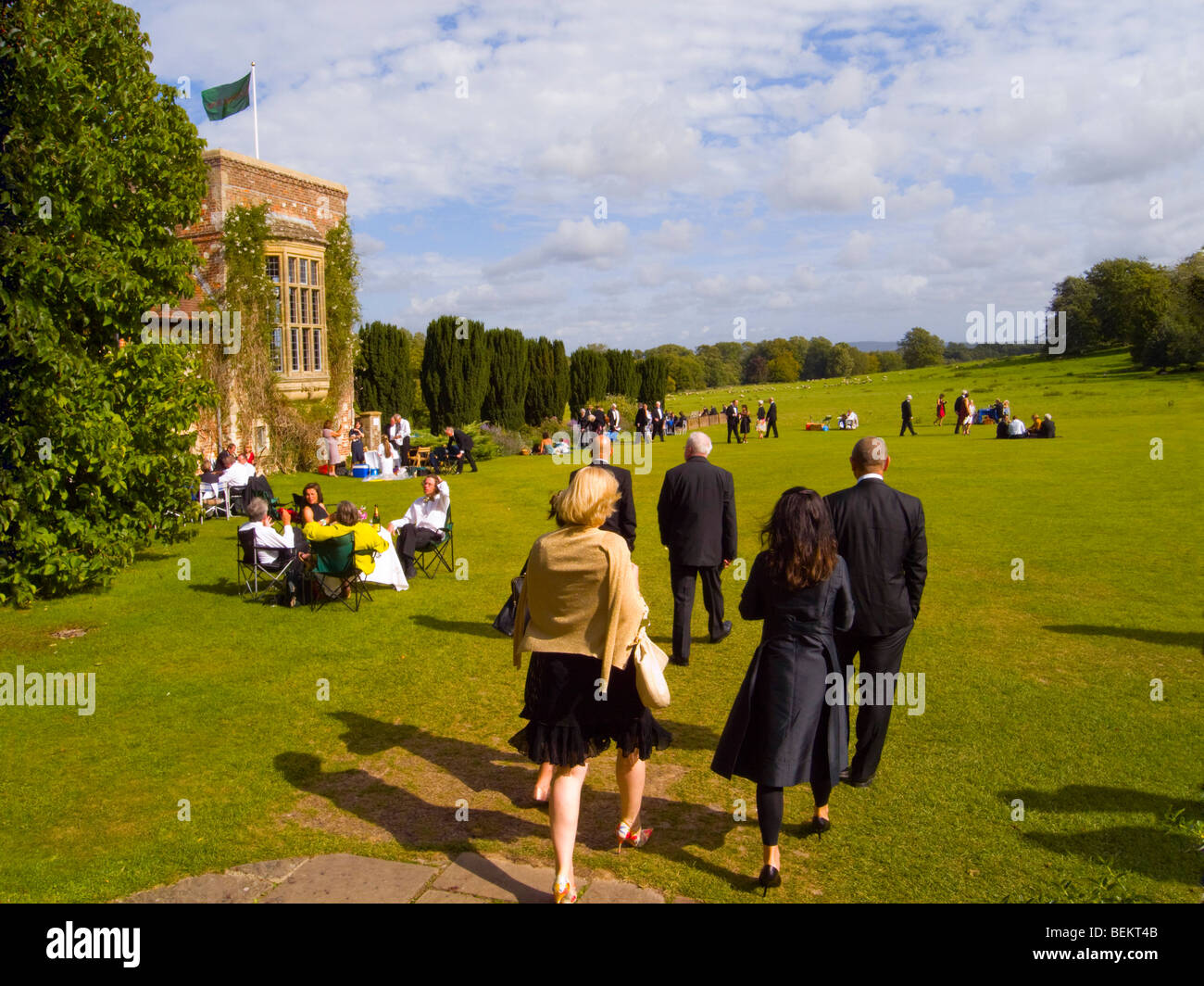 Menschen genießen Picknicks und ein Spaziergang in den Gärten am Glyndebourne Opera House Stockfoto