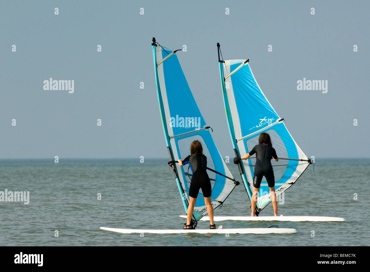 Zwei junge Mädchen Windsurfen entlang der Nordseeküste Stockfoto