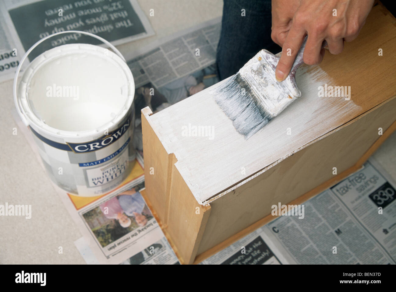 Nahaufnahme von Hand mit Pinsel malen Weißlack auf Schublade Stockfoto