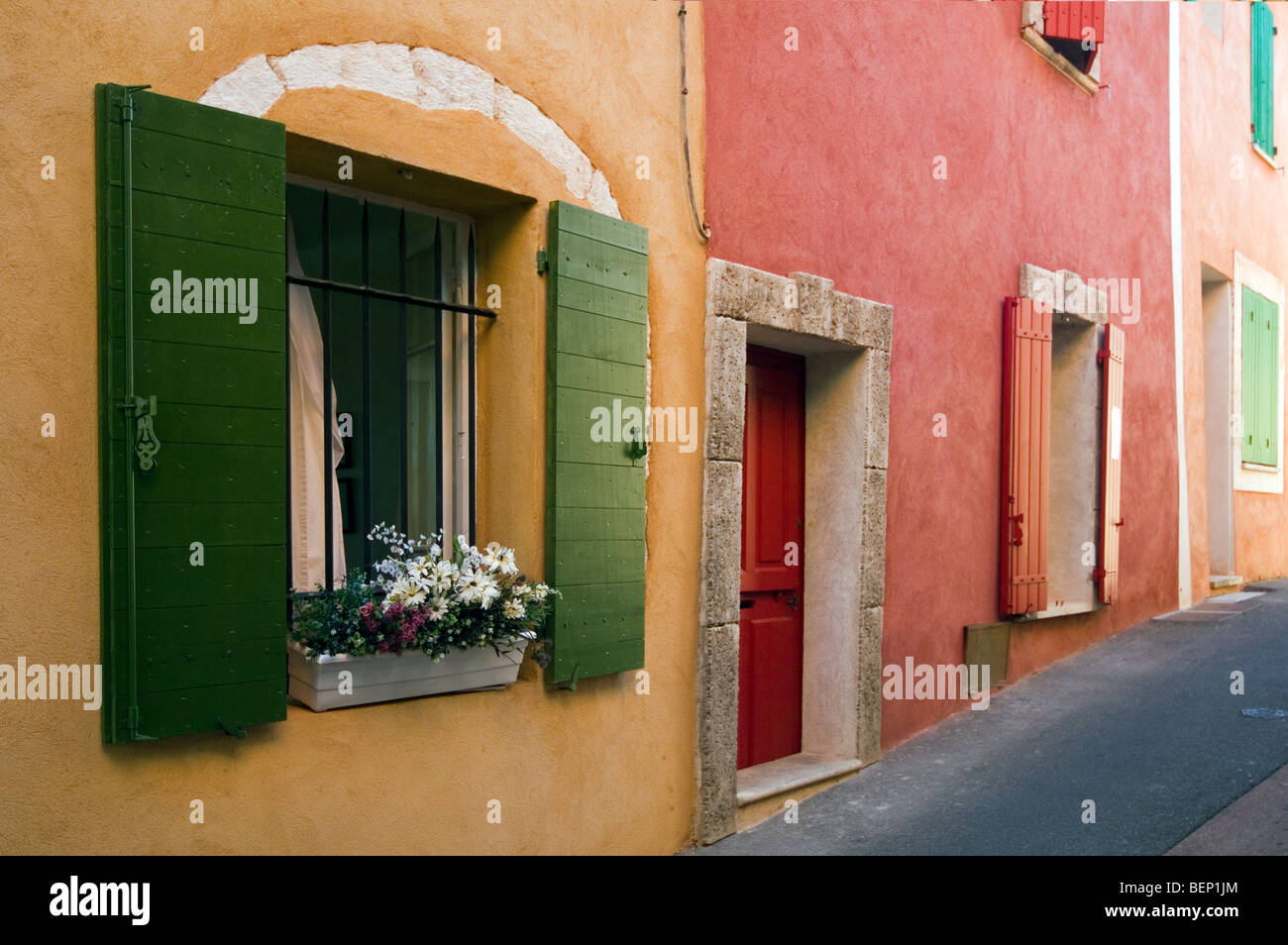 Bunten Fassaden der Häuser mit Sonnenrollos, Roussillon, Provence, Vaucluse, Provence-Alpes-Côte d ' Azur, Frankreich Stockfoto