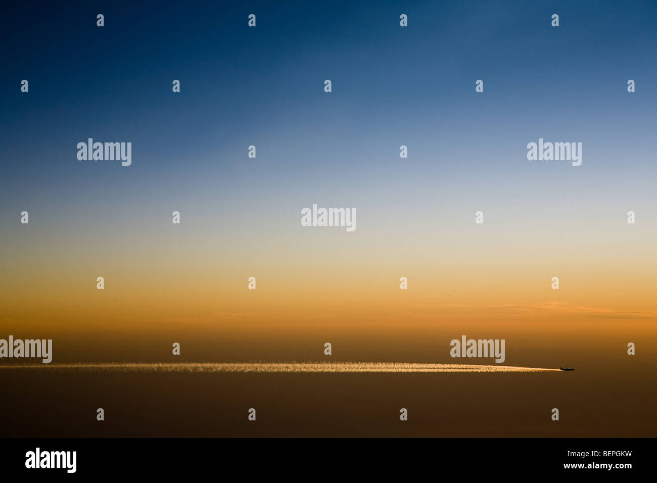 Flugzeugflügel vor einem dramatischen Sonnenuntergang Dämmerung Himmel Stockfoto