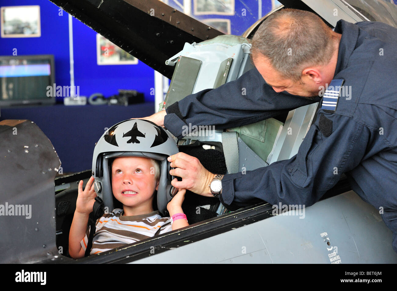 Kind im Cockpit mit Kampfjet-pilot Helm auf Airshow in Koksijde, Belgien Stockfoto
