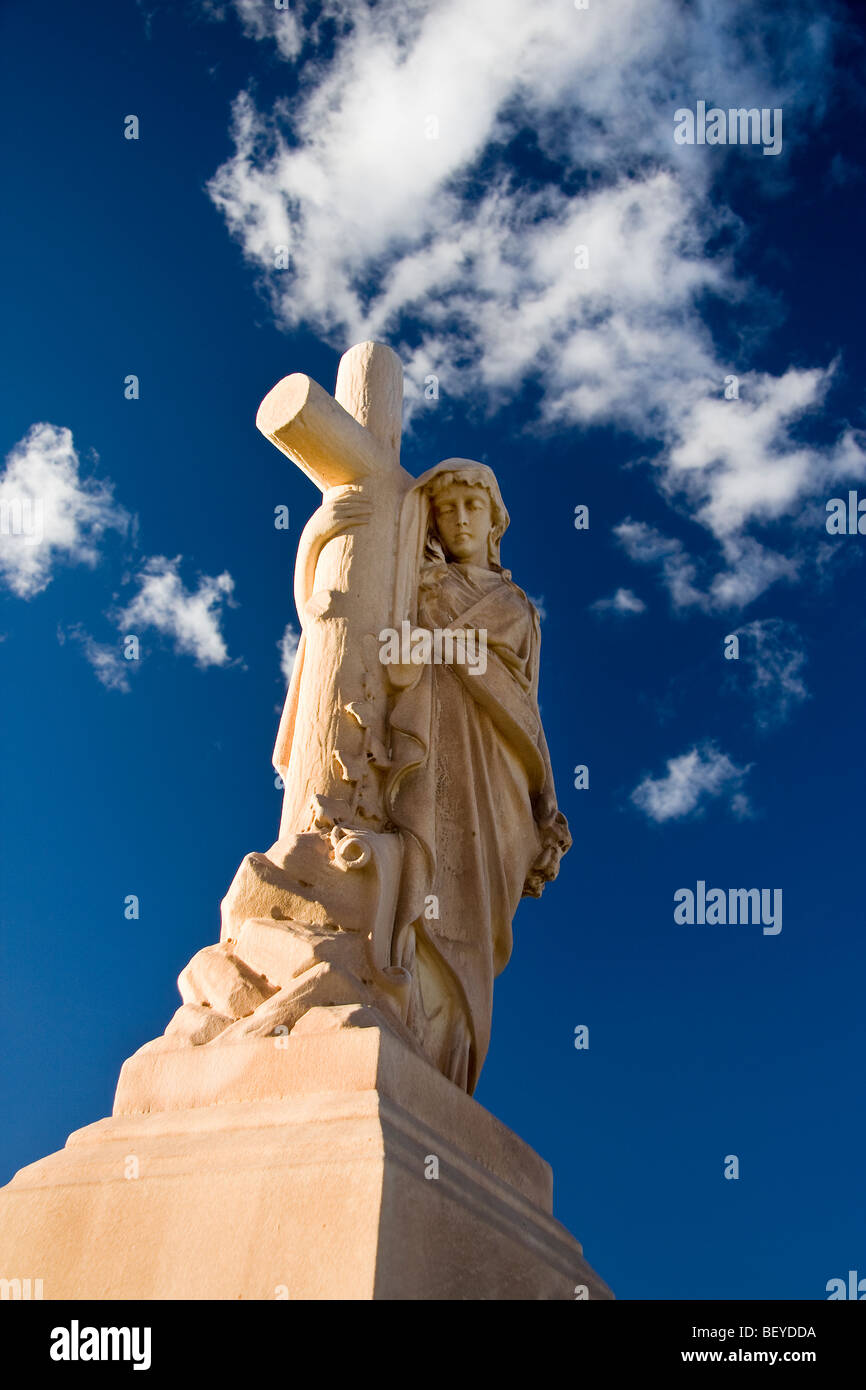 Eine Statue einer Frau "unterstützt" durch "das Kreuz" auf dem "Evergreen Friedhof" in "Bisbee, Arizona." Stockfoto