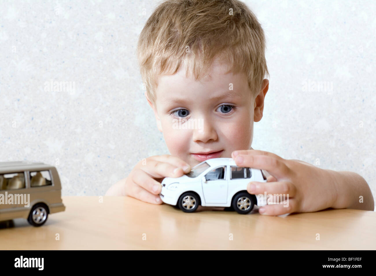 Ein kleiner Junge spielt mit einem Spielzeugauto Stockfoto