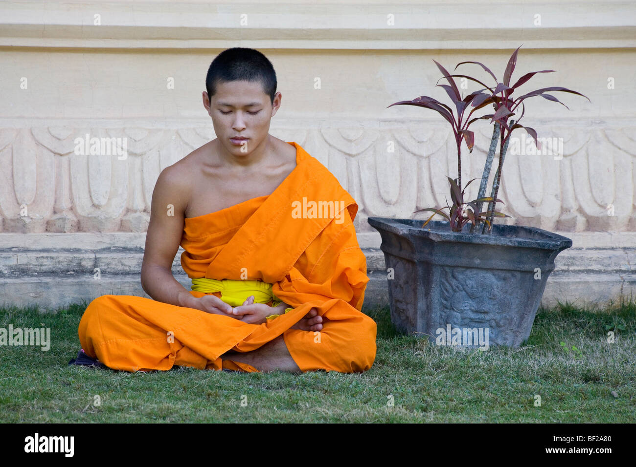 Buddhistische Mönch sitzt vor Kloster MwSt Pa Phonphao, Luang Prabang, Laos Stockfoto