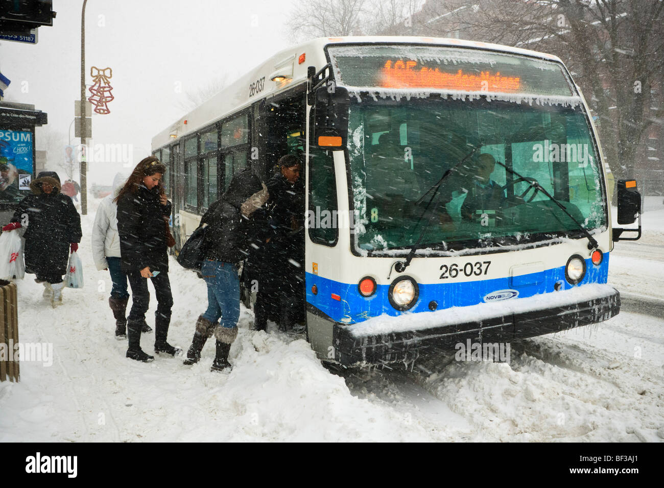 Menschen, die einsteigen in eines Bus bei einem Wintersturm Schnee auf dem Plateau in Montreal. Stockfoto