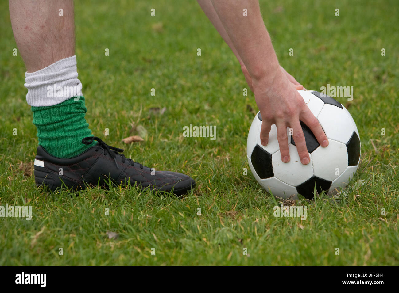 platzieren den Ball nach unten für einen Kick Fußballspieler Stockfoto