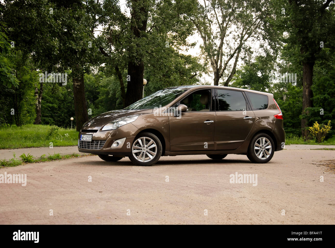 Renault Grand Scenic 1,9 dCi - 2009 - braun Metallic - fünf Türen (5D) - Französisch kompakt-van (MPV) - kleine Straße in einem Park, Sett Stockfoto