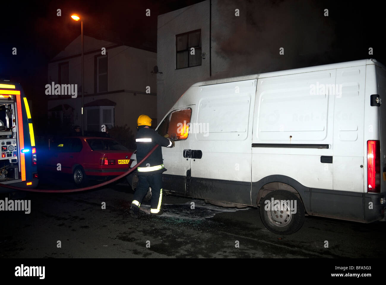 Weißen Transit van am Feuer bei Nacht Brandstiftung Stockfoto